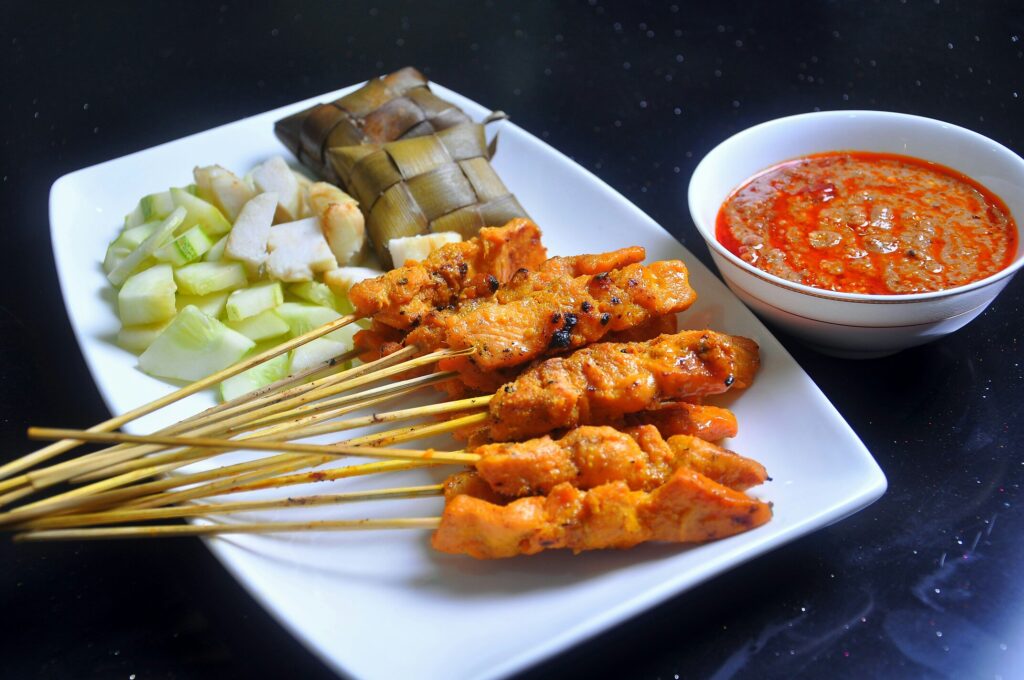 Malay Cuisine in SG : Satay skewers caramelised over smoky charcoal fire with classic accompaniments.