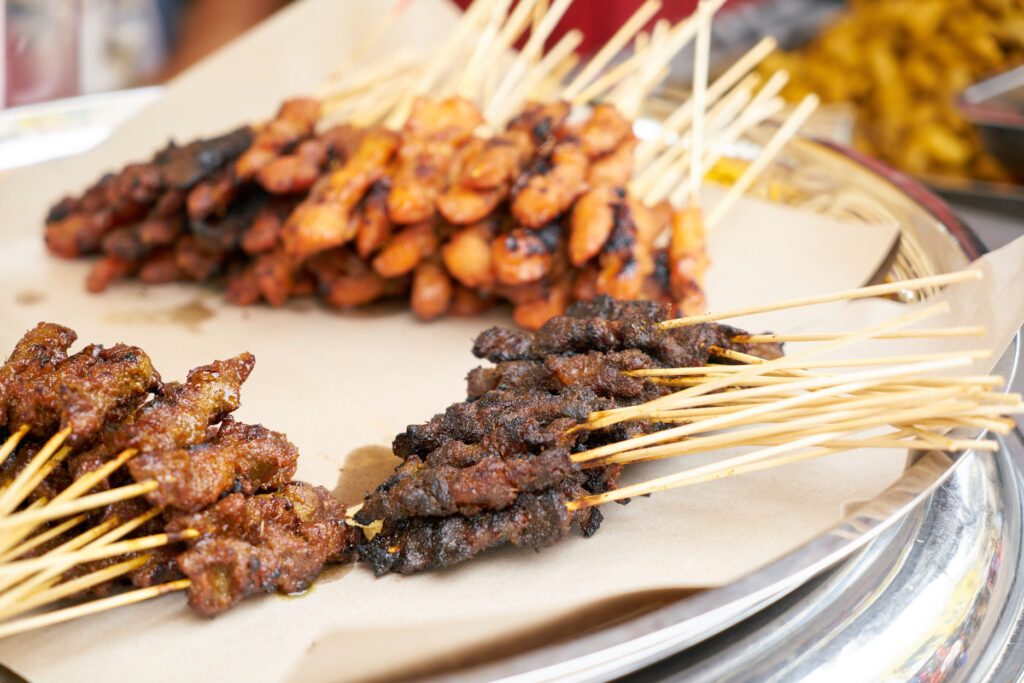 Malay Cuisine in SG : Satay skewers caramelised over smoky charcoal fire with classic accompaniments.
