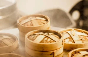 Chinese Cuisine: Dim sum baskets filled with har gow, siu mai, and fluffy buns