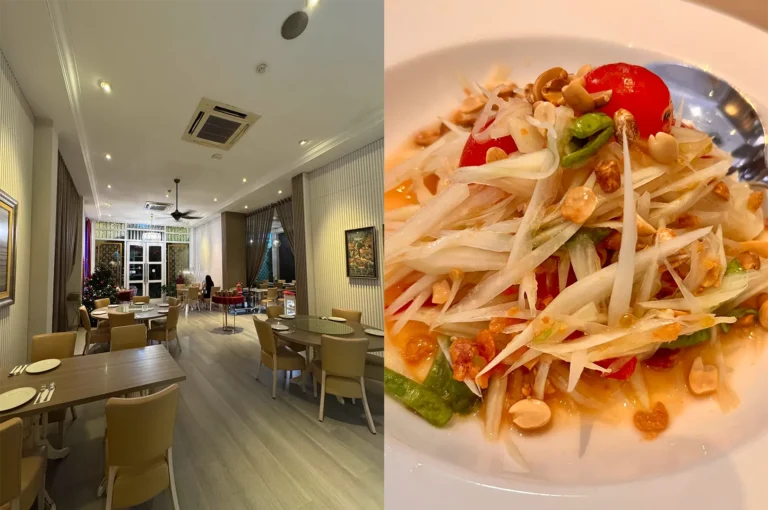 A clean and spacious Thai restaurant interior with round and rectangular dining tables and a vibrant plate of spicy Som Tum green papaya salad with peanuts.
