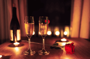 Elegant romantic rooftop dining Singapore scene at a rooftop bar with two champagne flutes, a red rose, and flickering candles on a table, perfect for a romantic date night or special occasion at rooftop restaurants overlooking Marina Bay, the Singapore skyline, and Marina Bay Sands. Capturing the ambience of romantic restaurants and the most romantic restaurants in the city, this fine dining restaurant in Singapore blends contemporary Asian cuisine and Italian restaurant influences, offering great food, signature cocktails, steaks, wine, and imaginative menu creations by an executive chef. Guests enjoy impeccable service, a la carte dishes, new menu highlights, and stunning views of the Singapore Flyer, city skyline, and city lights. Ideal for corporate events, lunch, dinner, or afternoon bites, the location at Collyer Quay offers breathtaking views at sea level with skyline views that soak in the world‑class backdrop. The rooftop space invites dining under the night sky, where friends and couples sip drinks, explore flavours, and feast on quality food paired with cocktails, wine, and steaks. The elegant yet casual atmosphere makes it a celebration to miss at your peril, with every bite a delight and every note of taste a blend of fun and romance. Perfect for sunset, evening, or date experiences, this destination offers access to the east and beyond, making it a must‑visit for restaurants lovers who want to literally explore the best dining, bar, and event spaces in Singapore.