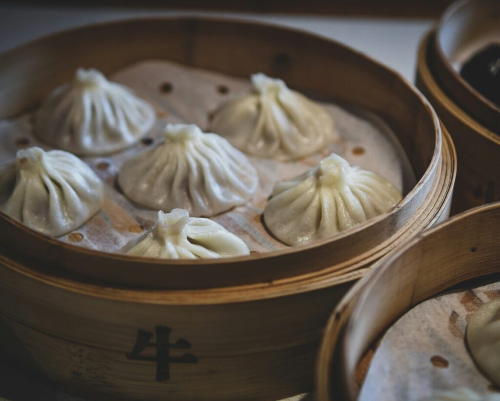 Chinese Cuisine : Steaming basket of xiao long bao showcasing delicate craftsmanship