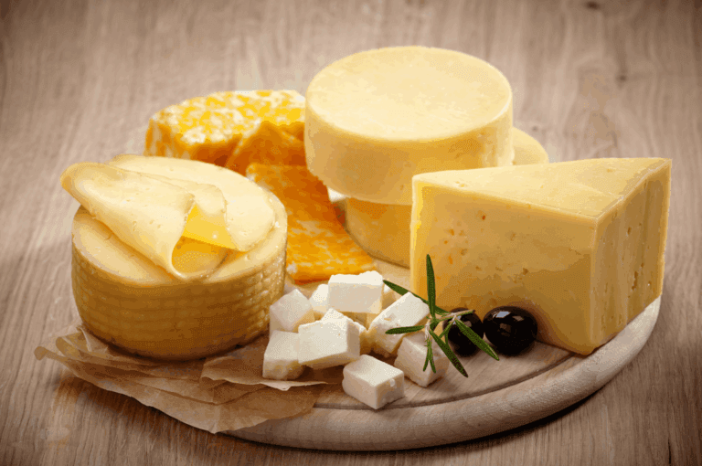 Artisan cheese platter showcasing authentic Italian cuisine and Italian food, beautifully arranged with expert food styling in an Italian restaurant, featuring mozzarella cheese, parmesan cheese, buffalo milk cheeses, and wedges of baked and cooked varieties from northern Italy and southern Italy. This traditional dish reflects Italy’s long history of Italian dishes, iconic dishes, and pasta varieties, typically served alongside fresh pasta, stuffed pasta, pizza, bread, risotto, and indulgent desserts. The selection is complemented by olive oil, extra virgin olive oil, fresh vegetables, herbs, oregano, garlic, ripe tomatoes, potatoes, and pine nuts, with various sauces such as tomato sauce, meat sauce, pesto sauce, and balsamic vinegar dressings. Inspired by Emilia Romagna recipes and crafted with wheat flour, dough, butter, melted butter, milk, lemon juice, lemon, salt, and prosciutto, these cheeses pair perfectly with main courses, meat, beef, chicken, seafood, and vegetables. This great food celebrates a deep connection to Italy’s culinary heritage, where the primary ingredient and flavor profile vary depending on the dishes, offering many variations in meals, desserts, and recipes that highlight cheese, sauce, and food traditions from across Italy, making it a centerpiece in both casual and fine dining experiences.