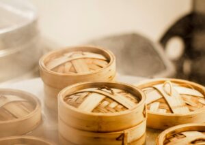 Chinese Cuisine: Dim sum baskets filled with har gow, siu mai, and fluffy buns