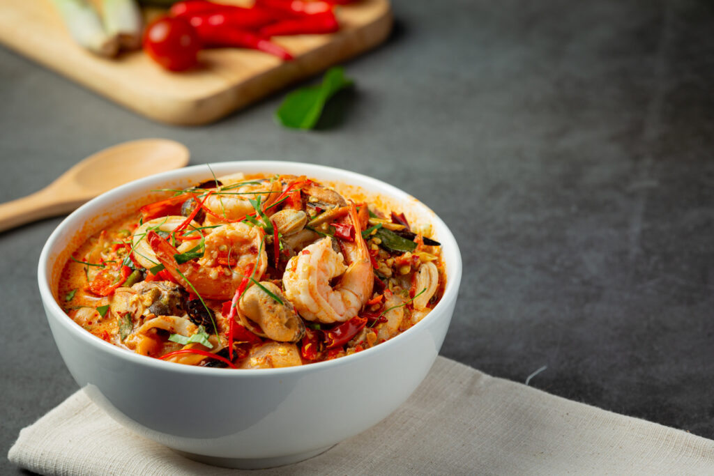 Thai Cuisine in Singapore : Aromatic tom yum soup highlighting fresh seafood ingredients
