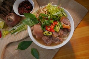 Vietnamese Cuisine in SG: Traditional beef noodle soup served with aromatic sides
