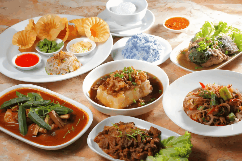 A vibrant spread of Peranakan dishes on a communal table, featuring colorful curries, sambals, and shared plates, highlighting Singapore’s rich culinary heritage.