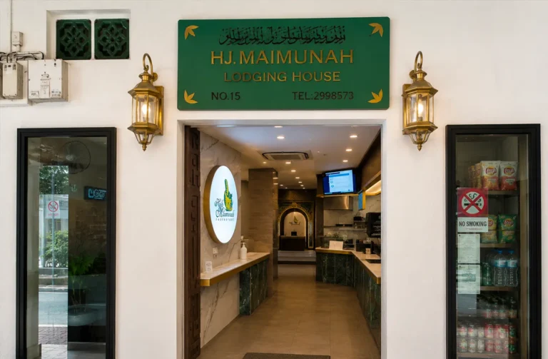 Storefront entrance of Hj. Maimunah Lodging House and Restaurant with green signboard