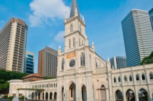 A view of CHIJMES, a historic site in Singapore, featuring beautiful architecture and lively outdoor spaces.