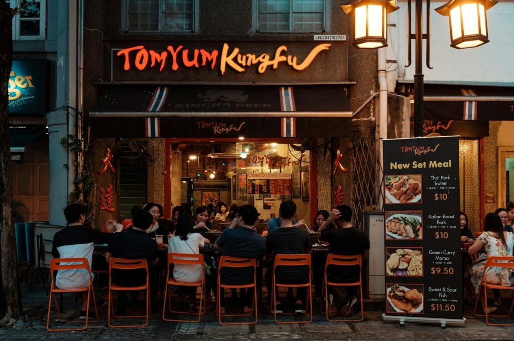 Exterior view of a restaurant in Singapore, showcasing its inviting entrance and vibrant signage.