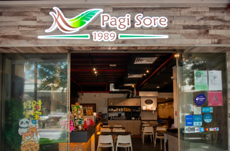 Pagi Sore 1989 restaurant storefront with wooden signage and glass entrance