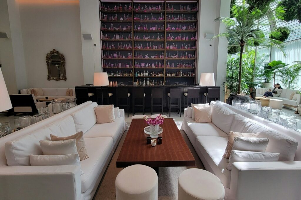 Elegant white living room with white couches and a bar, ideal for capturing Instagram-worthy moments in Singapore.