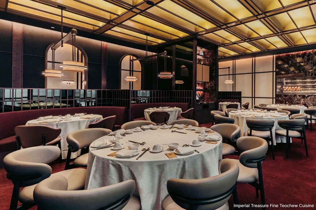 A lavish dining room at Imperial Treasure showcases rich red and gold decorations, reflecting the restaurant's fine Teochew cuisine.