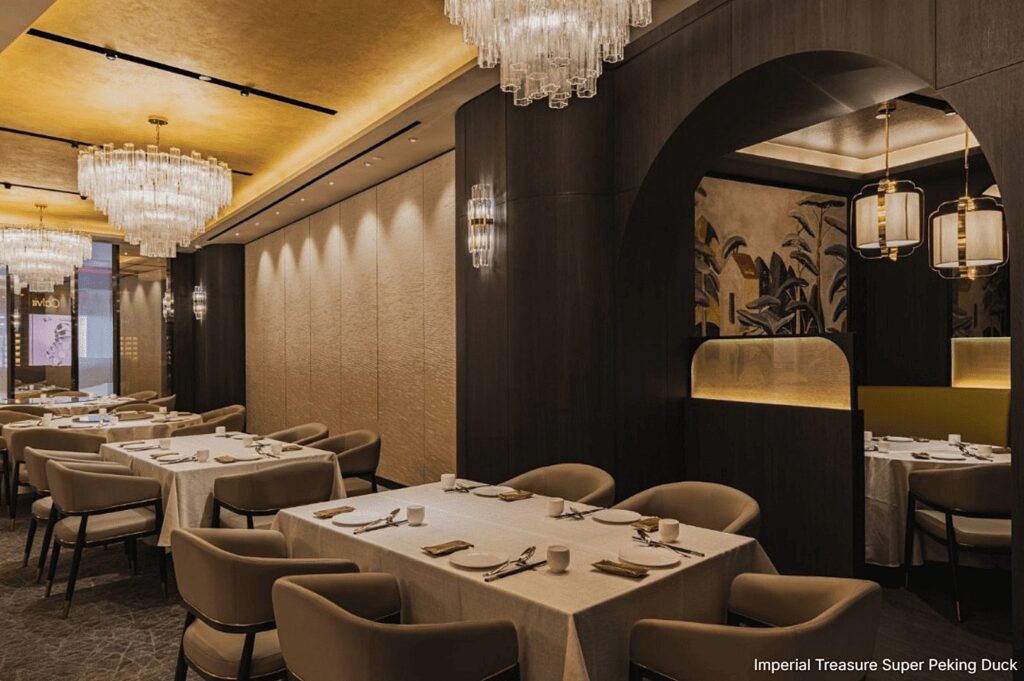 Luxurious dining space with a grand chandelier and gold details, at Imperial Treasure Super Peking Duck.