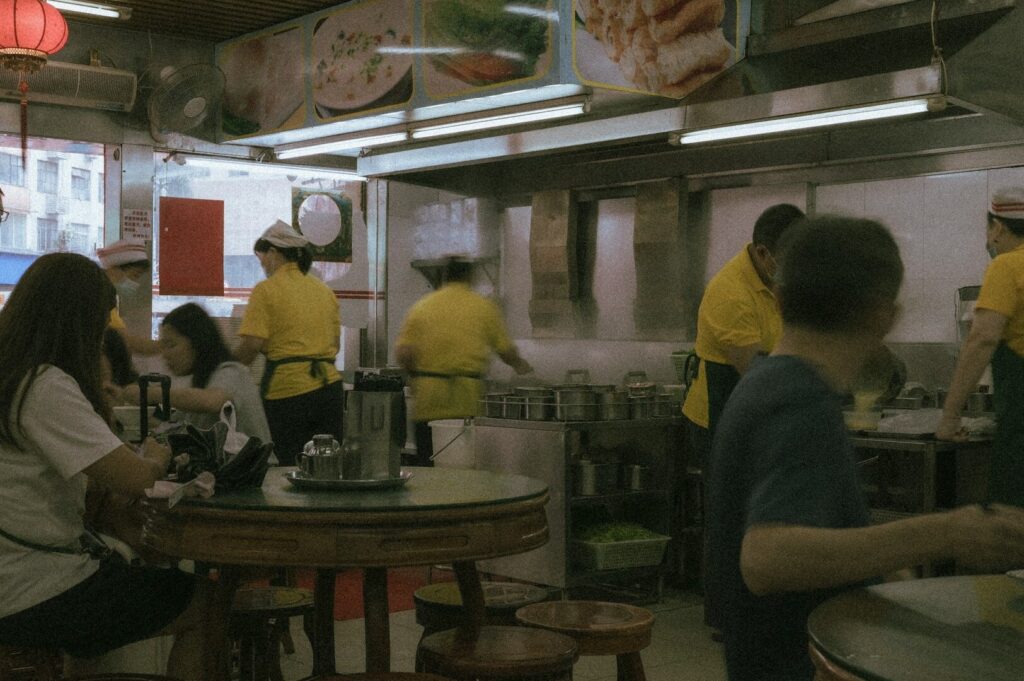 A diverse group of people enjoying a meal together in a local restaurant in Singapore.