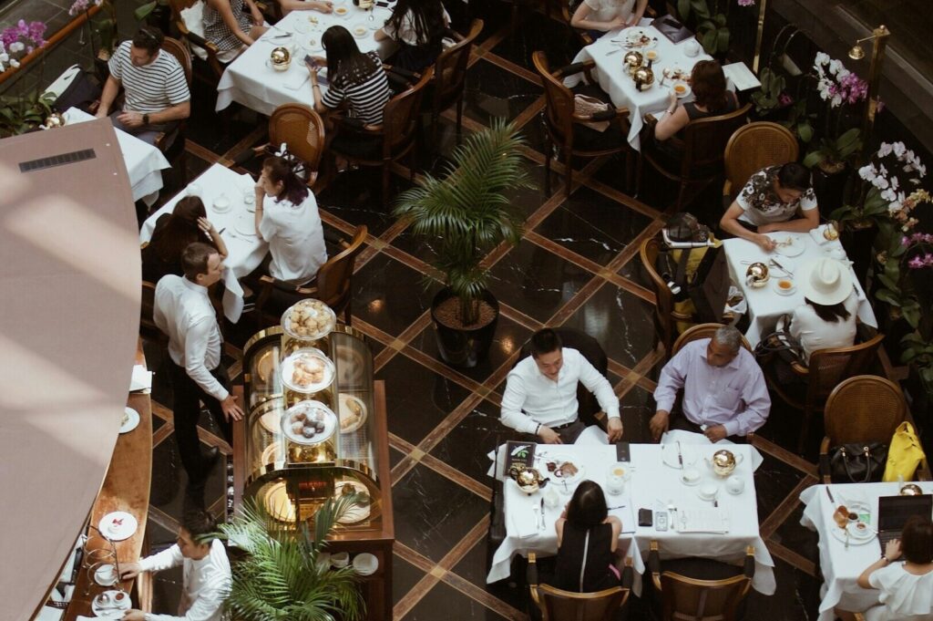 A bustling restaurant in Singapore with diners enjoying meals at tables, creating a lively atmosphere.
