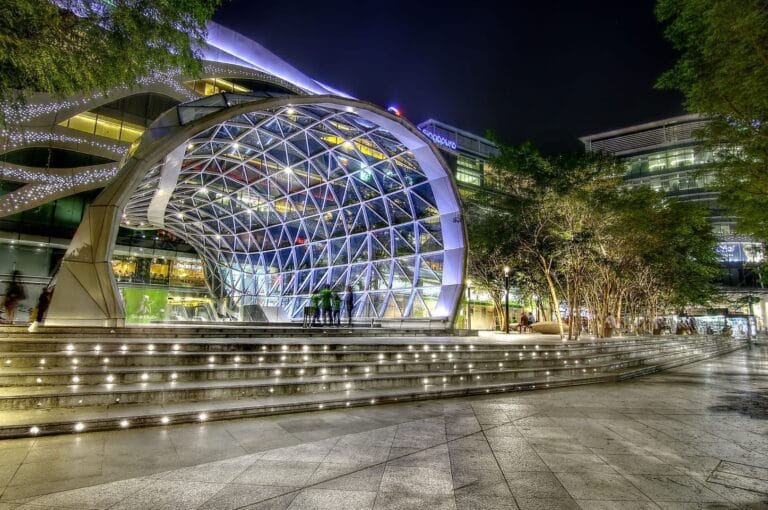 Plaza Singapura, a building with a glass roof, showcasing modern architectural design.