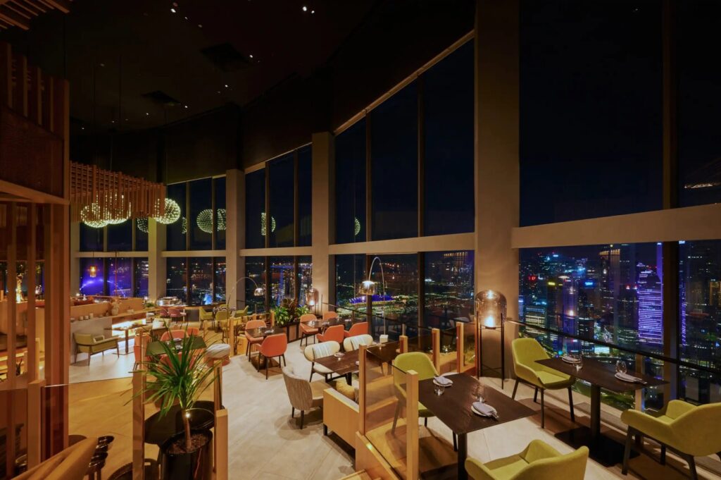 Scenic view from SKAI rooftop bar, highlighting Singapore's skyline and urban landscape.