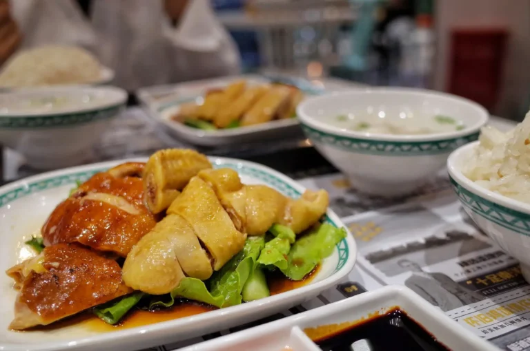 A plate featuring rice and meat, showcasing a premier dining experience in Singapore.