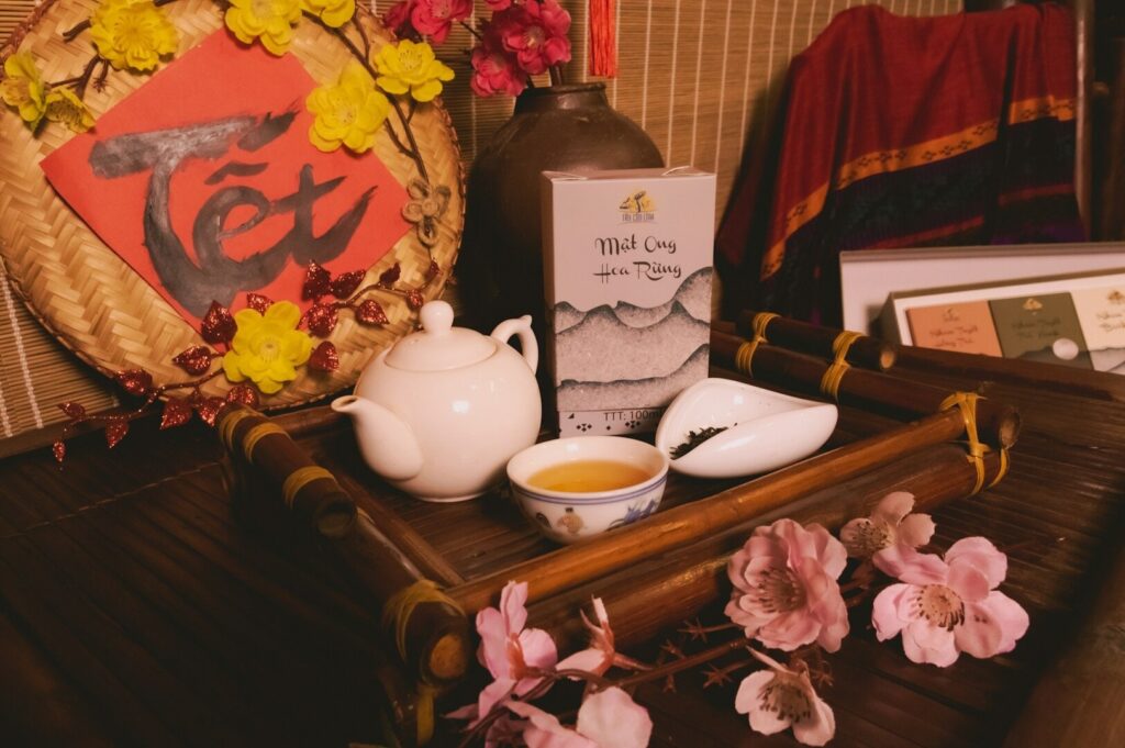 A tray featuring a teapot, teacups, and fresh flowers, set in a serene Chinese tea room ambiance.