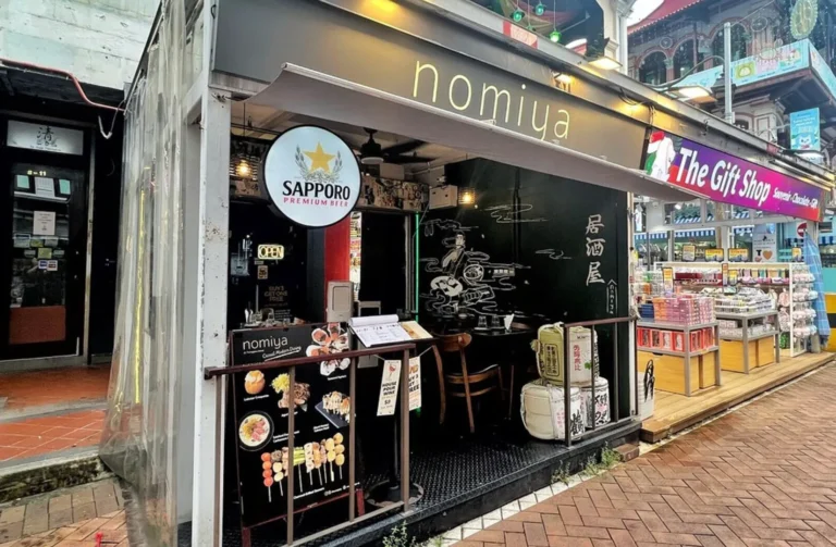 Exterior view of a cozy restaurant named "Nomiya," showcasing its identity as a Singapore Izakaya.