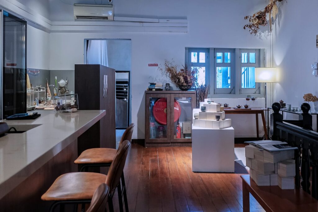 Interior of SILK Tea Bar on Sago Street, showcasing a kitchen with a counter, table, and chairs.