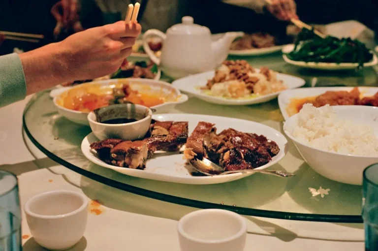 A round table set with an array of gourmet dishes, showcasing premier dining in Singapore.