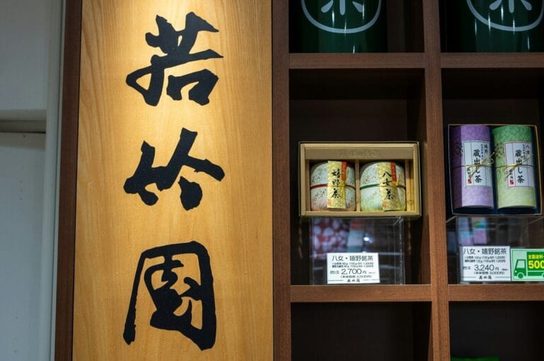 A display of various teas alongside writing on shelves in the Chinese Tea Room, Singapore.