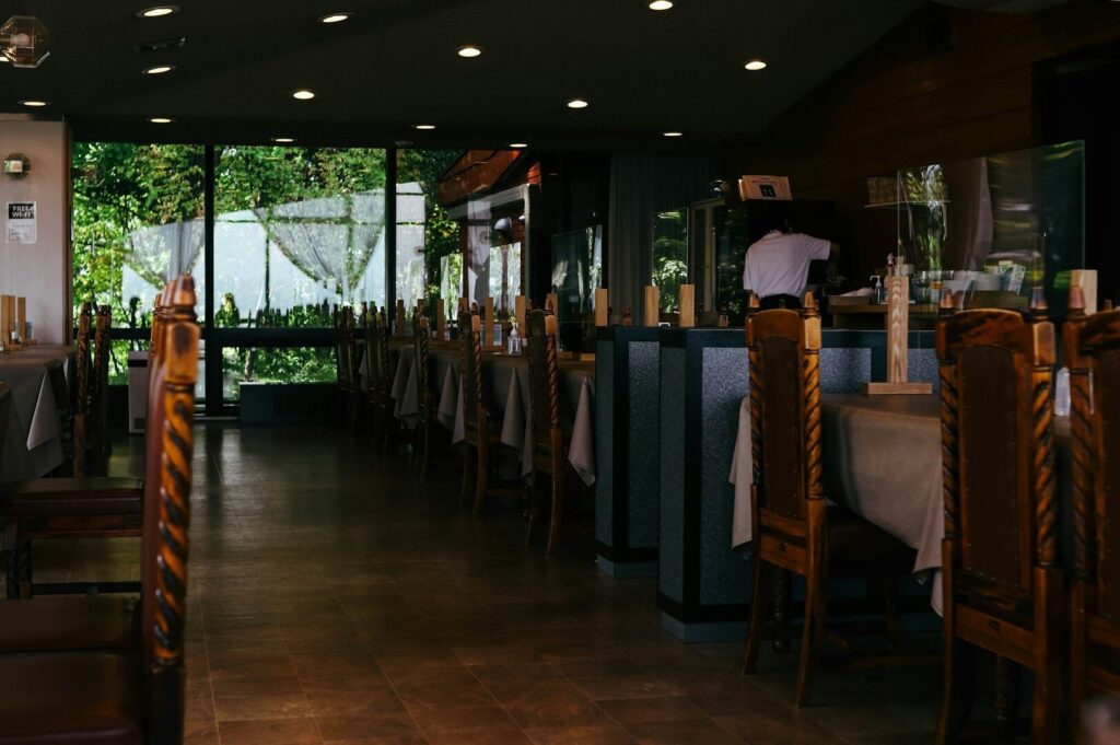 Interior of a Singapore restaurant showcasing many tables and chairs, creating a lively dining atmosphere.