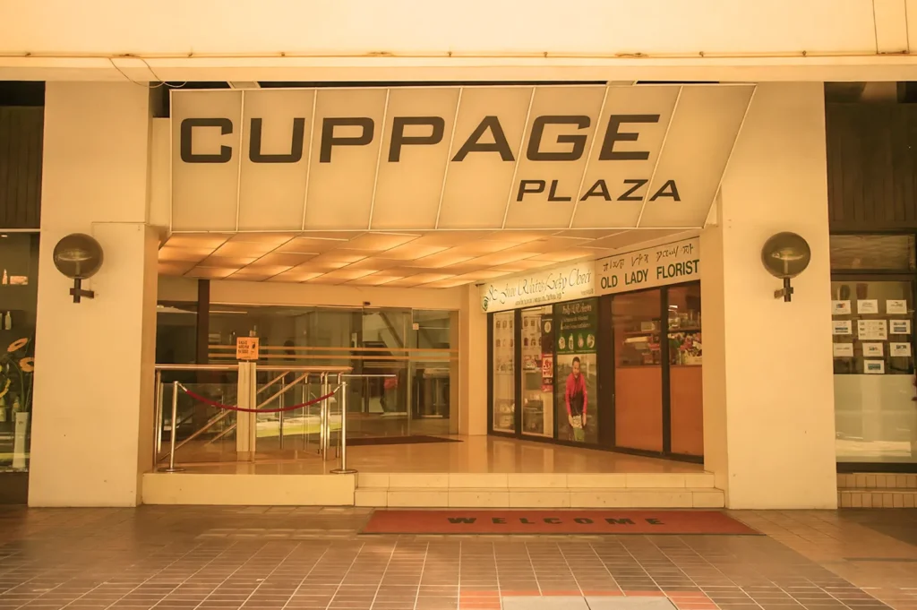 Cuppage Plaza shopping mall entrance with covered walkway, storefronts, and main signage