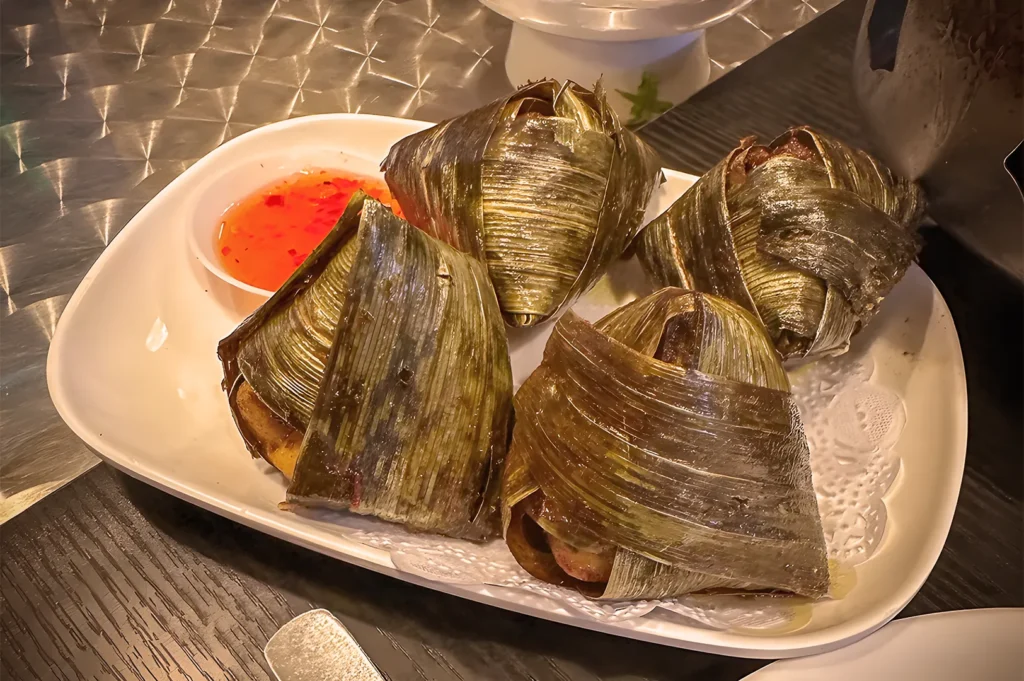 Traditional Thai Pandan Chicken (Gai Hor Bai Toey) served at Nakhon Kitchen, featuring marinated chicken wrapped in pandan leaves with sweet chili dipping sauce.