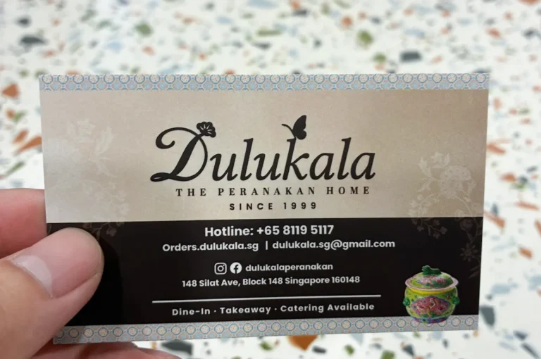 Dulukala The Peranakan Home business card showing contact details, address at Silat Ave, and website information.