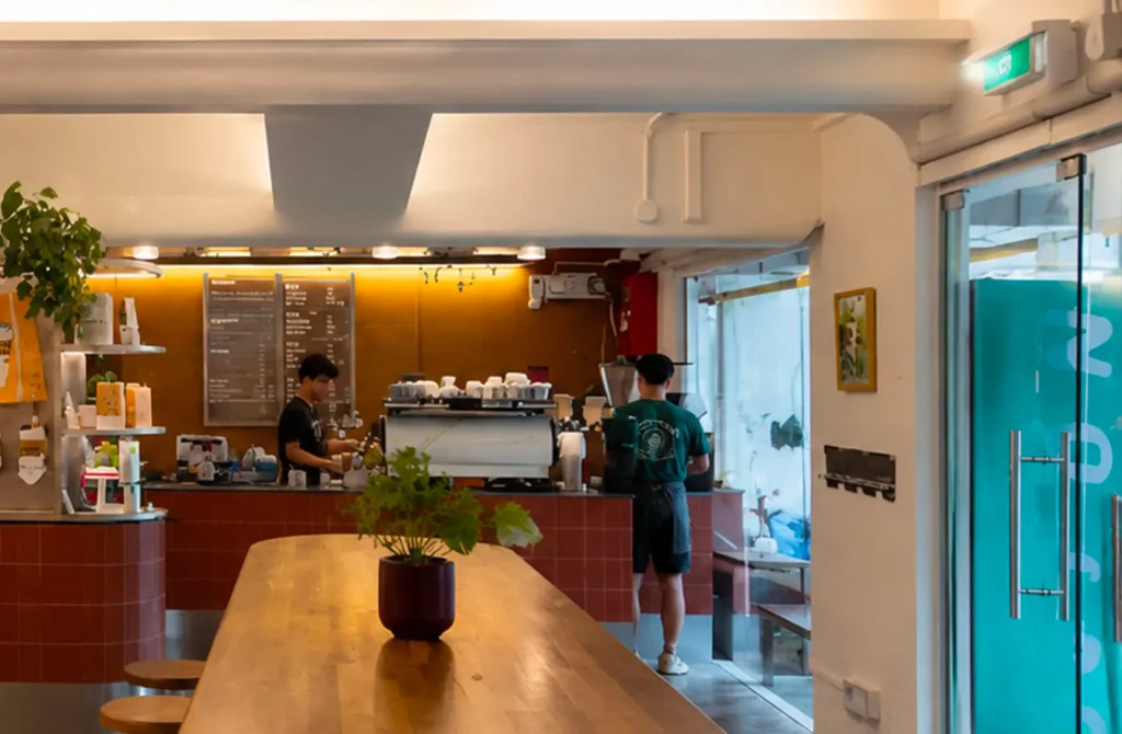 Modern café interior with bar counter and baristas preparing drinks