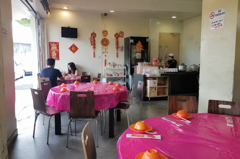 Hidden Singapore restaurant interior with pink tables and Chinese décor