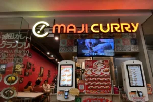 Maji Curry Singapore storefront with illuminated sign and restaurant entrance
