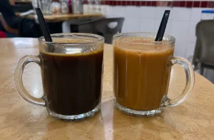 Traditional Singapore kopitiam serving kopi and teh in glass mugs.