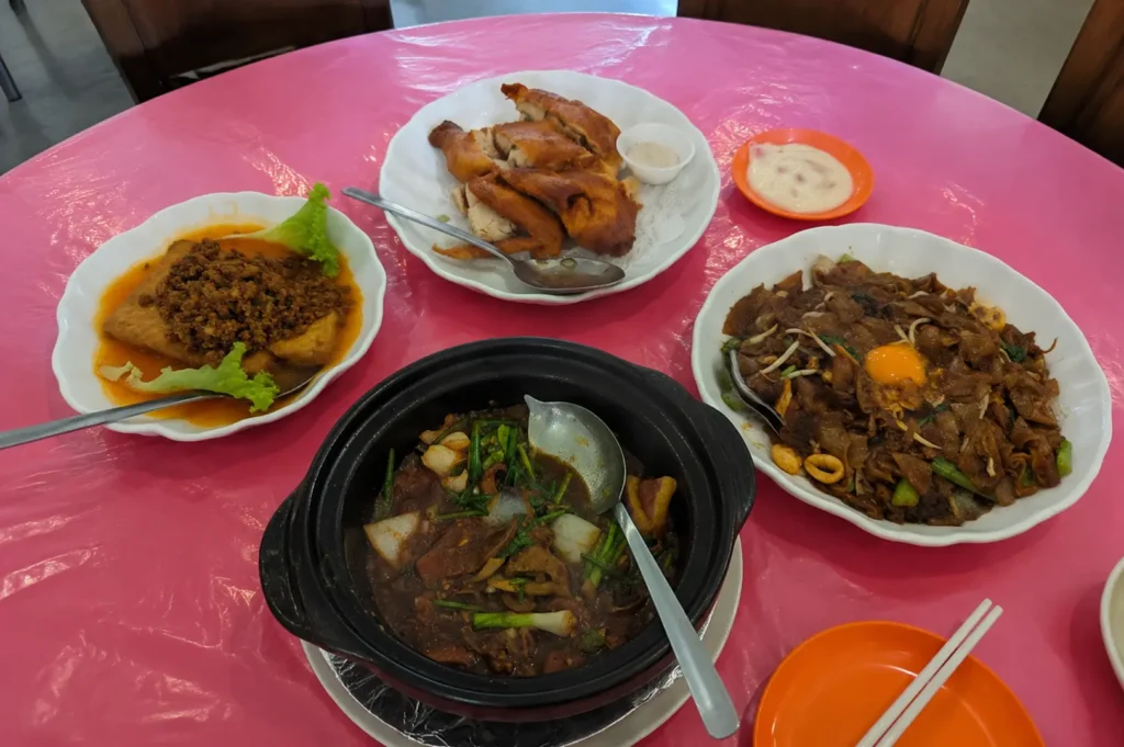 Delicious dishes served on a pink table at a hidden Singapore eatery