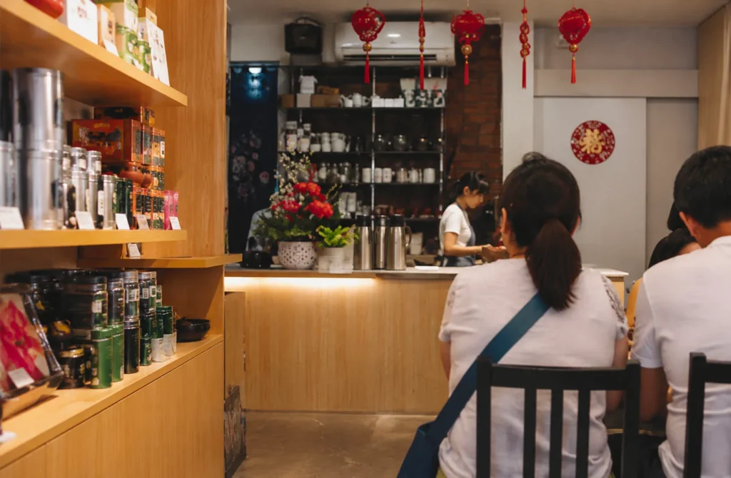 Warm dining space at Yixing Xuan Teahouse with tea displays and traditional Chinese décor.