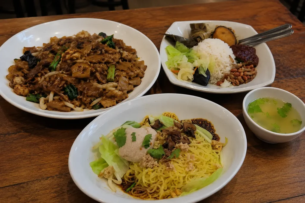 Vegetarian nasi lemak, mushroom minced meat noodles, and fried kway teow at Pine Tree Cafe.