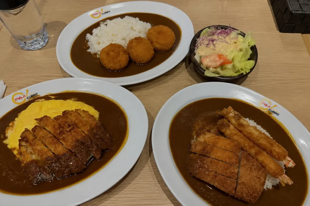 Maji Curry assorted curry rice dishes with fried toppings served on branded plates