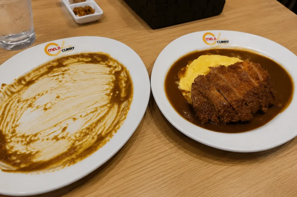 Maji Curry Singapore meal featuring curry rice, fried croquettes, and Japanese curry sauce